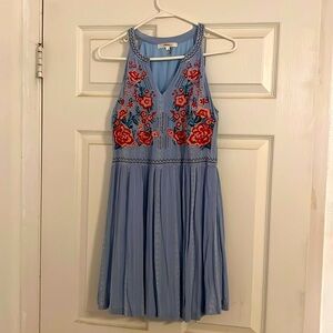 Embroidered razorback dress above knee length.